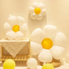 A display of white and yellow aluminum foil balloons arranged in a floral pattern.