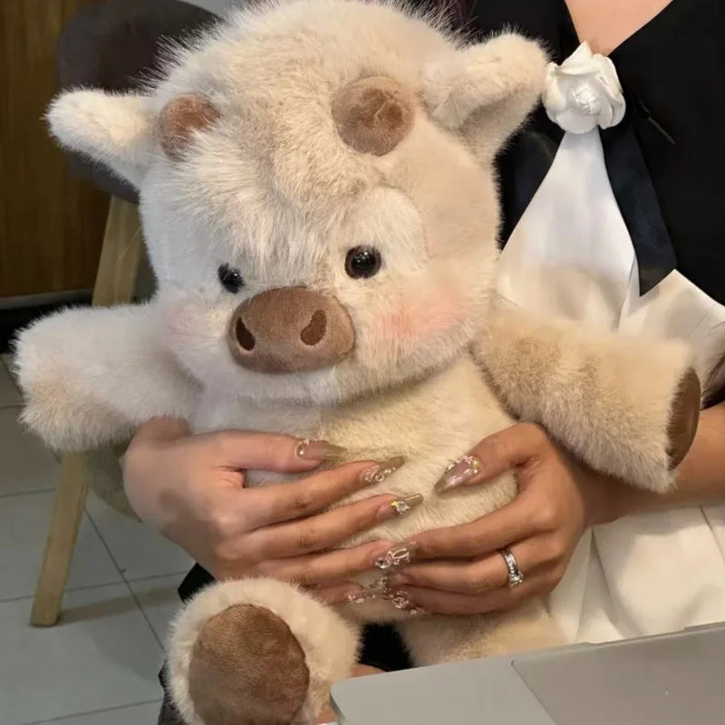 A person is holding a fluffy white West Highland Calf plush toy.