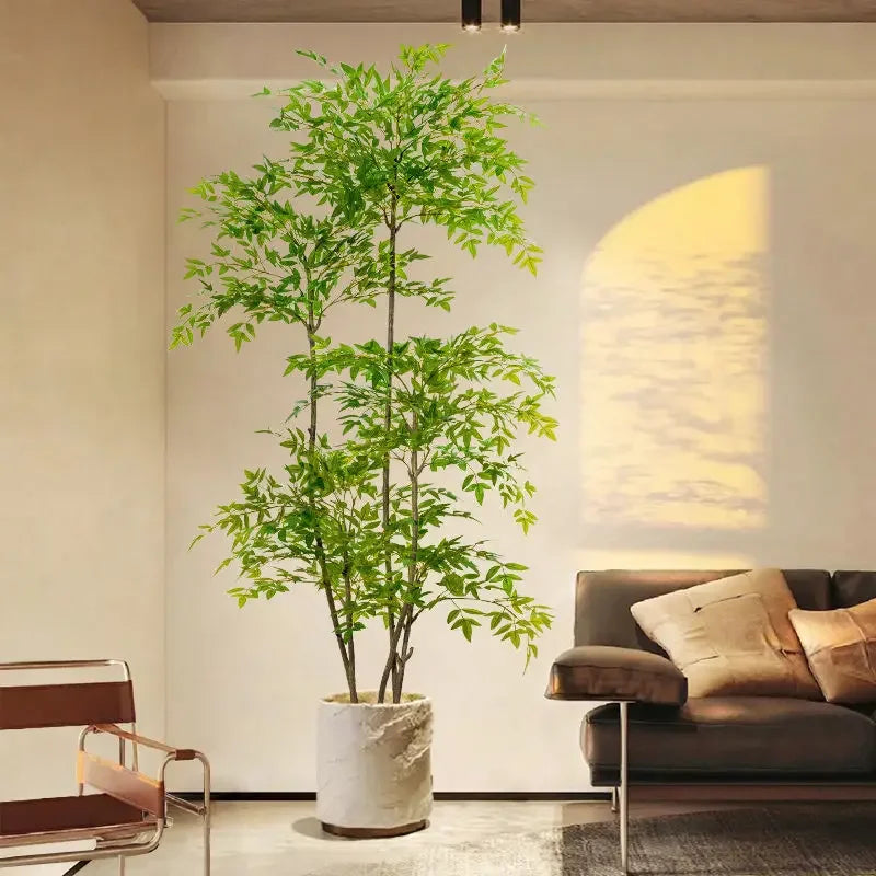 A tall artificial Nandina plant with bright green foliage is displayed indoors against a white wall.