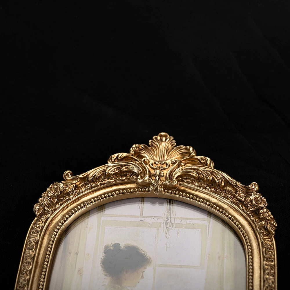 Ornate gold vintage resin photo frame with a distressed white background