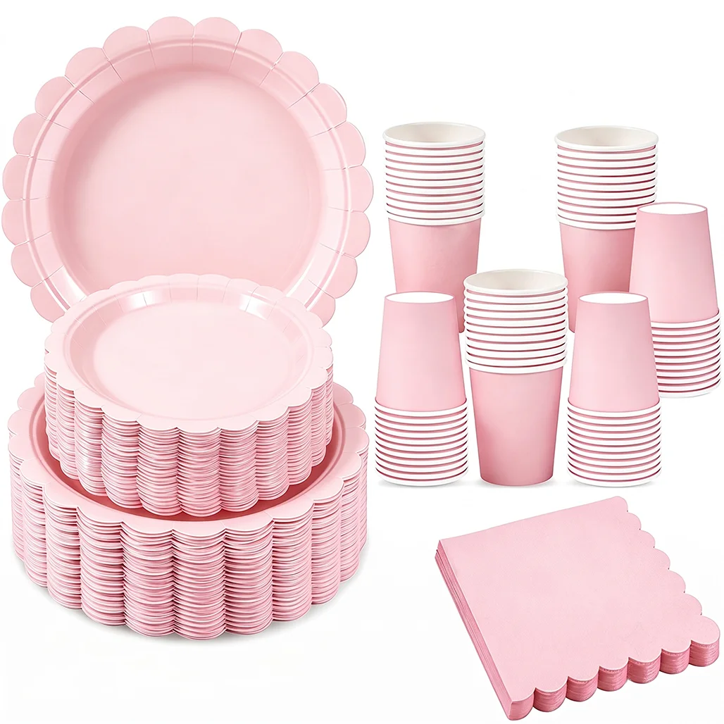 A pink scalloped paper tableware set including plates, cups, and napkins.