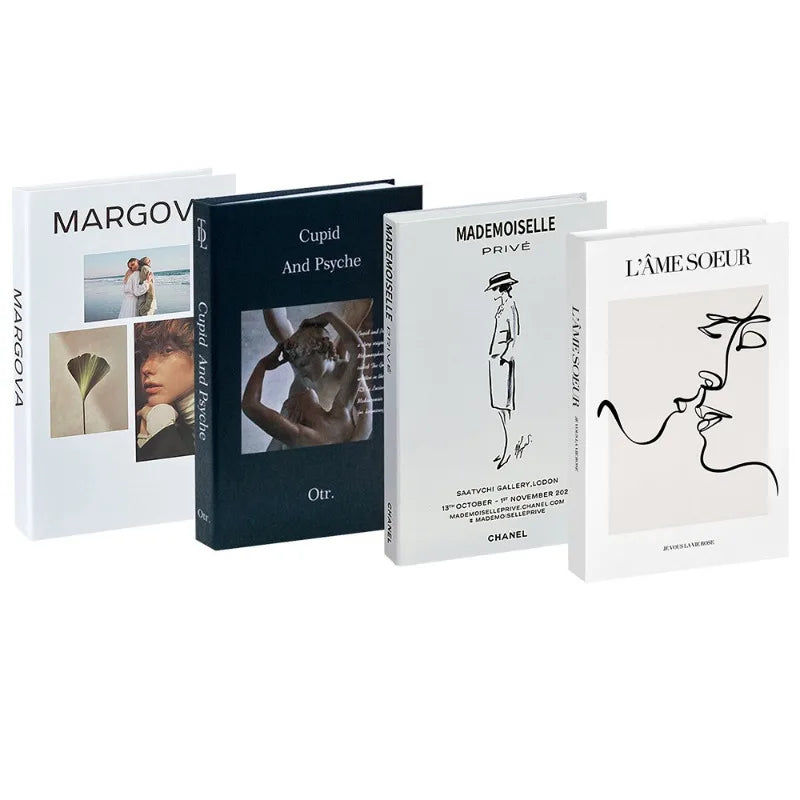 A set of three decorative faux books titled Margova, Cupid And Psyche, and Mademoiselle Prove.