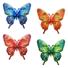 A set of four vibrant metal butterfly wall art decorations in blue, orange, red, and green.