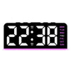 Reloj de alarma digital negro LED mostrando la hora 22:38 con un brillo rosa.