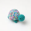 Handmade crocheted turtle plush with multicolored body and green feet