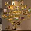 A wall collage featuring framed photos and gold leaf tree elements arranged in a family tree design.