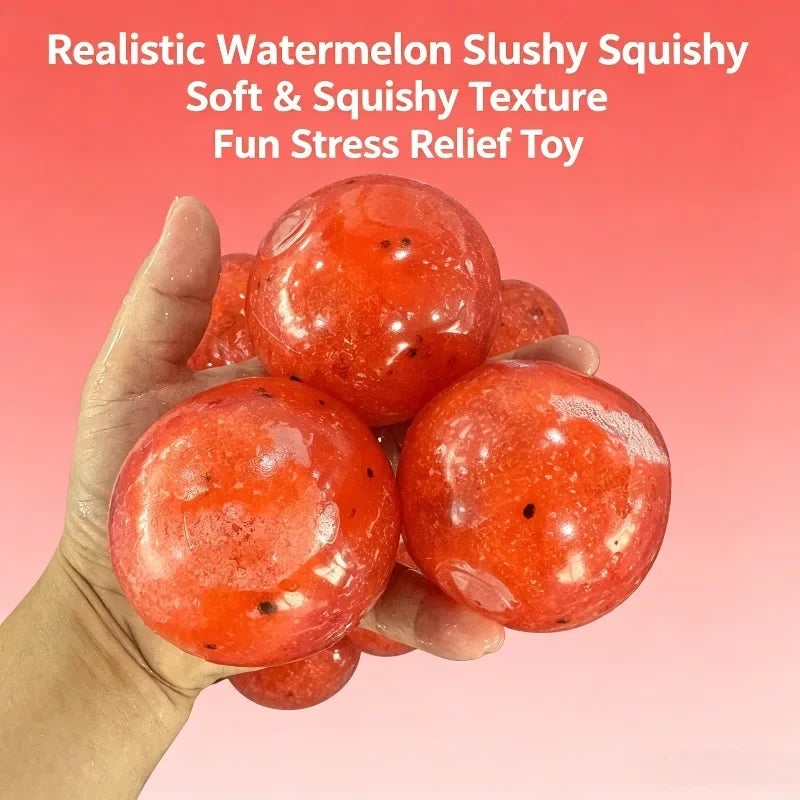 A hand holds several realistic, bright red watermelon-colored squishy toys.
