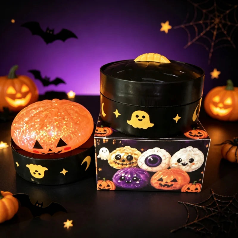 A black sensory squishy blind box containing various Halloween-themed pumpkin and ghost toys.