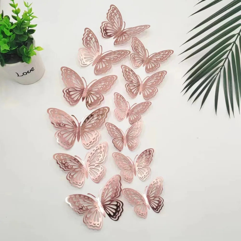 A set of twelve pink and brown 3D butterfly wall stickers arranged on a white surface next to a green plant and palm leaves.