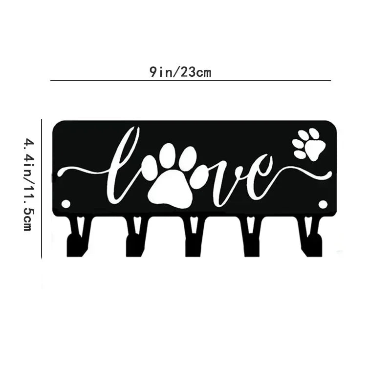 Black decorative metal key hooks for wall organization with a paw print and love design