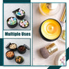 A set of metal candle tins with lids filled with colorful wax or beads, displayed alongside a lit candle and a brush.
