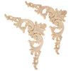 A set of two light oak wood corner carvings featuring intricate European branch and crown decorative motifs.