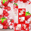 A set of strawberry theme birthday decorations featuring red and pink spherical ornaments and a banner.