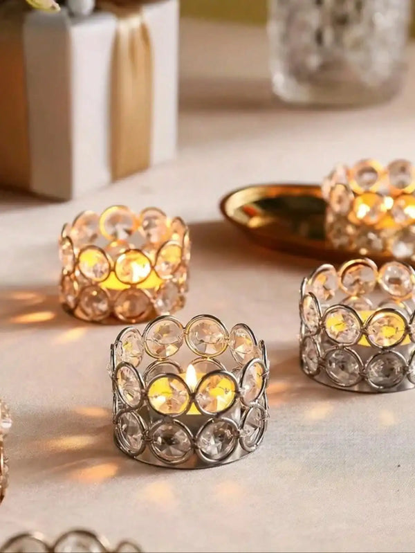 A close-up of a silver crystal lantern holder with warm yellow light illuminating small crystals.