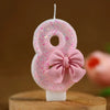 Set of number 8 cake topper candles in pink glitter with a pink bow