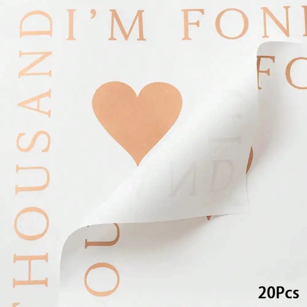 A sheet of peach-colored waterproof floral wrapping paper with a heart shape cutout and text visible.