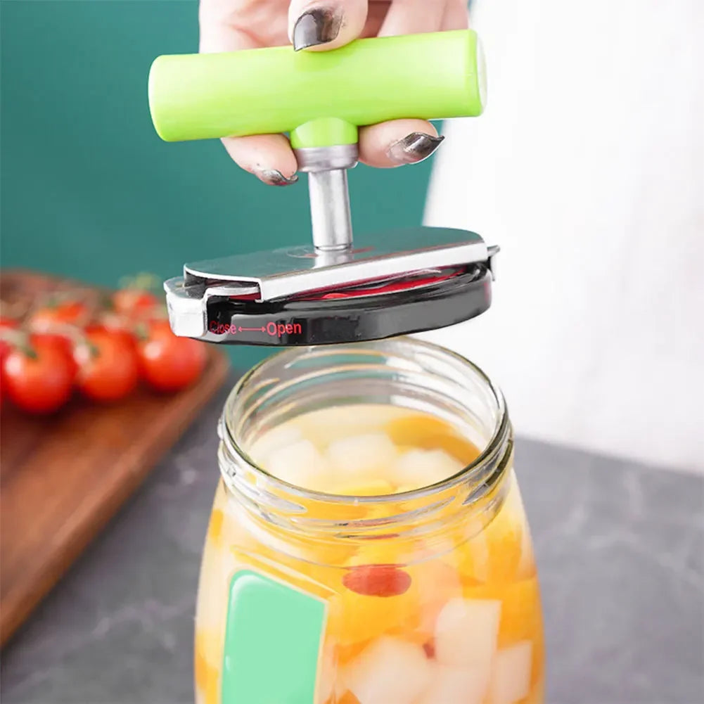 A hand is using an adjustable stainless steel jar opener to open a glass jar filled with fruit juice.