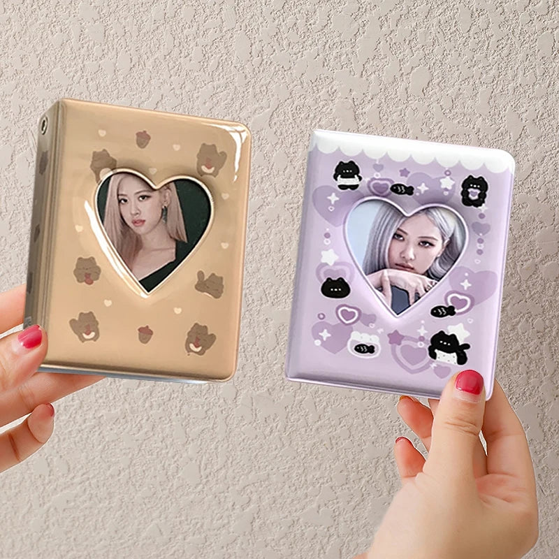 A pair of mini photo card album binders featuring a heart-shaped window with a female idol's face and decorative elements.