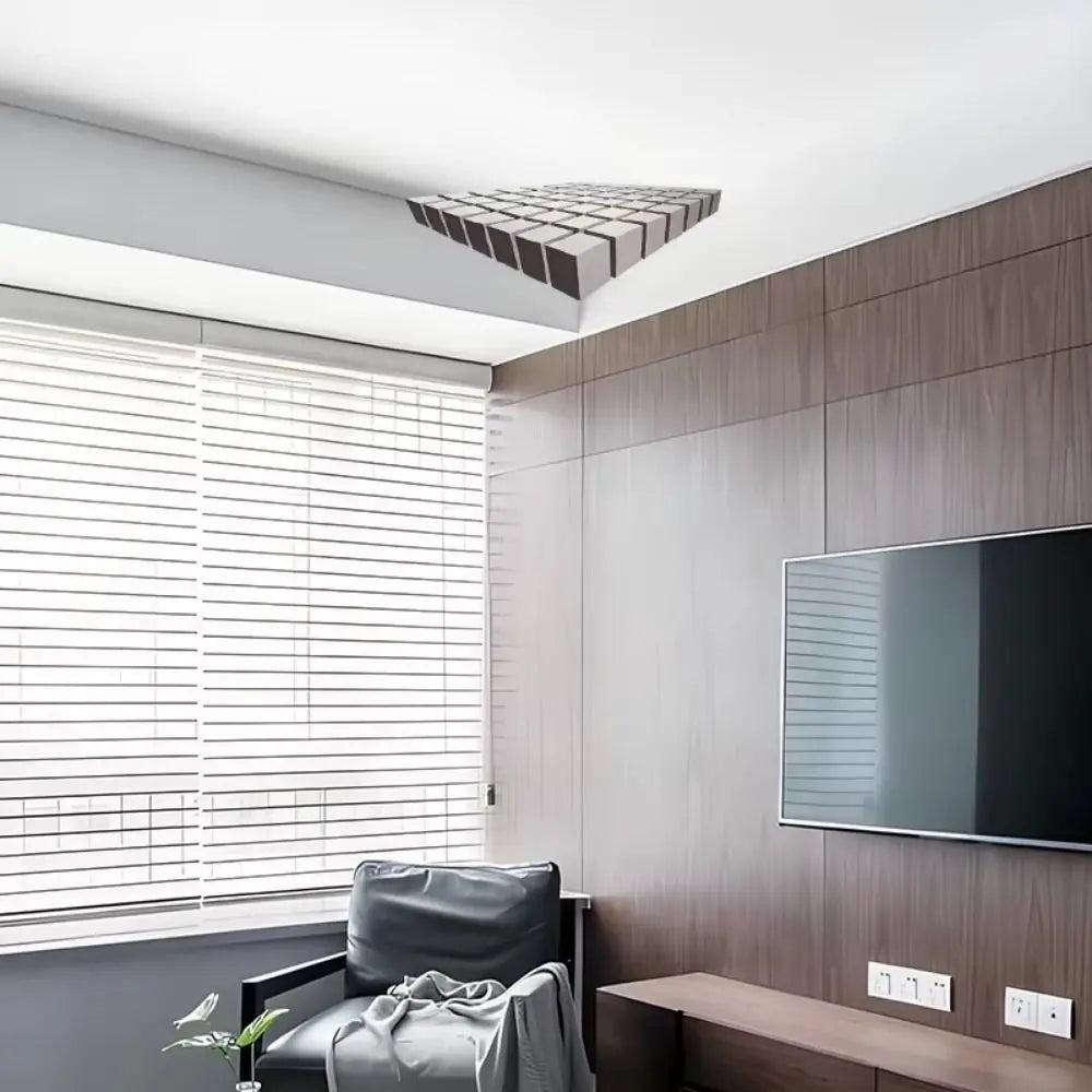 A modern interior featuring a wall with a dark wood paneling and a large television, next to a window covered by horizontal b