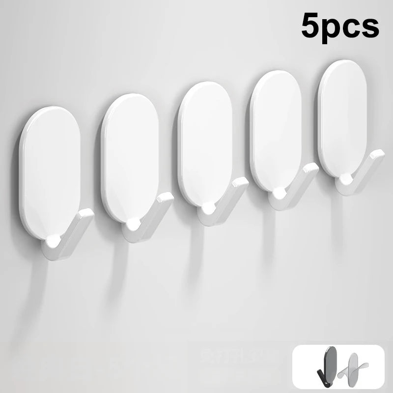 Five white self-adhesive wall hooks displayed in a row against a light gray background.