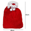 A festive red velvet Santa Claus gift bag with a white trim and pom-poms.