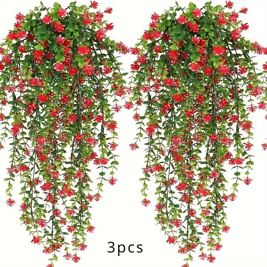 A set of three lifelike faux eucalyptus hanging plants with red flowers and green leaves.