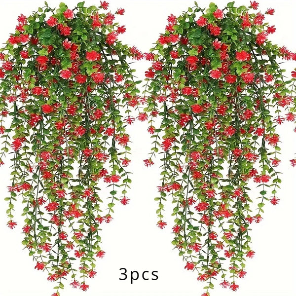 A set of three lifelike faux eucalyptus hanging plants with red flowers and green leaves.