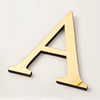 A gold acrylic mirror letter wall sticker shaped like the letter A