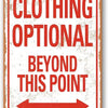 A vintage metal wall sign with red text that reads Clothing Optional Beyond This Point