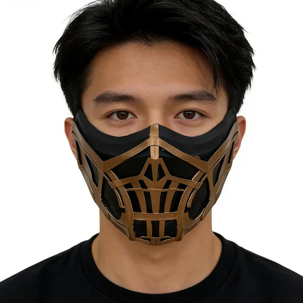 A close-up of a black and gold half-face mask cosplay featuring Mortal Kombat characters Sub-Zero and Scorpion.