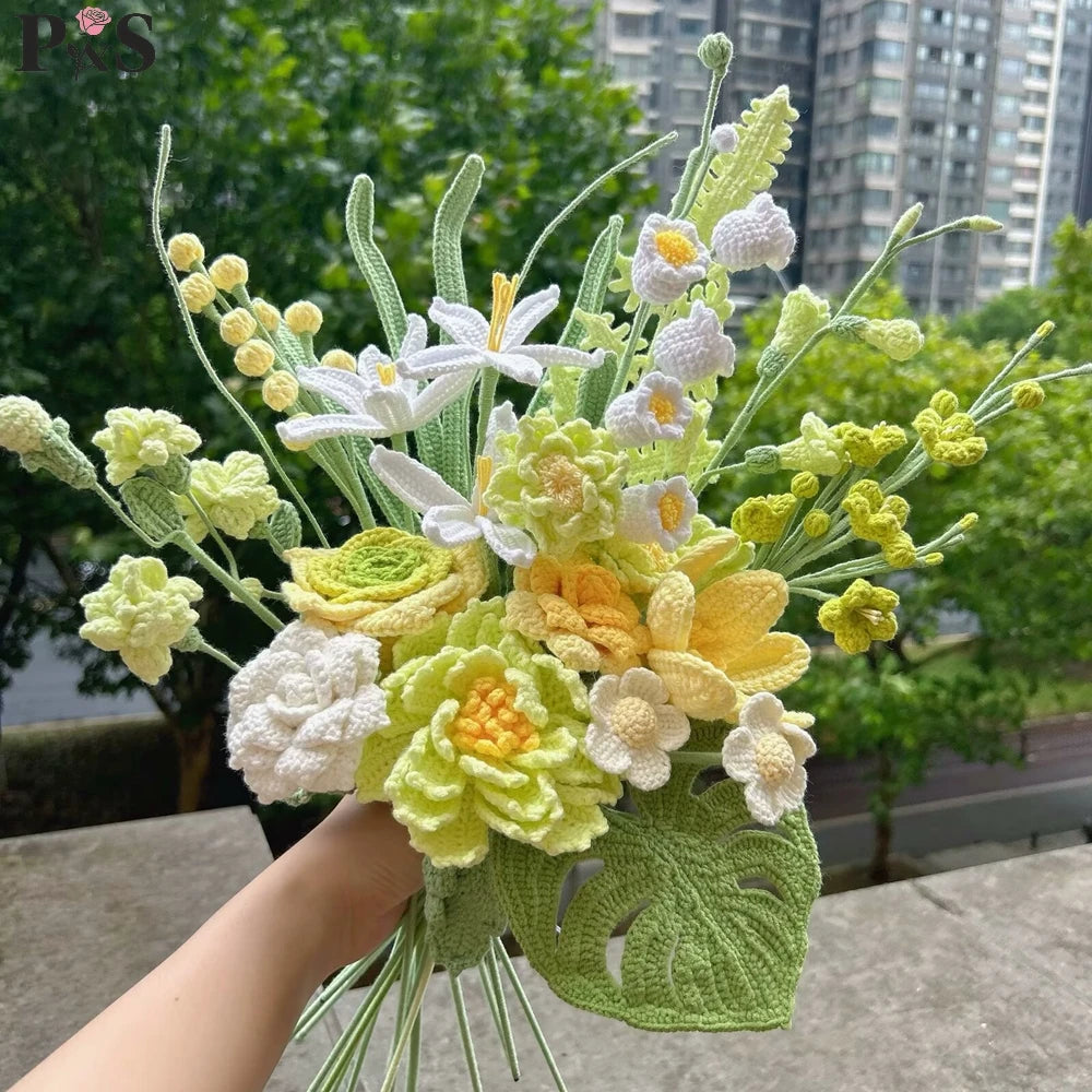 Handmade crochet flower bouquet featuring white, yellow, and light green flowers arranged on a green leaf base