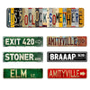 A collection of rustic metal signs featuring various phrases and locations like Its 5 o'clock Somewhere Exit 420 and Amityvil