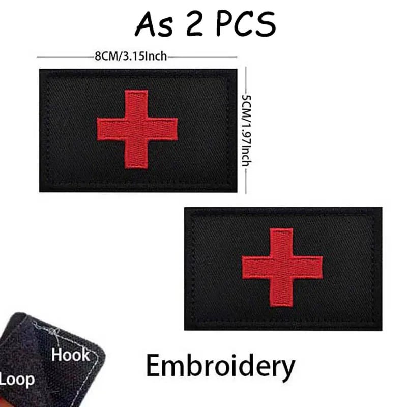 Two black embroidered medical cross patches with red crosses and a hook loop.