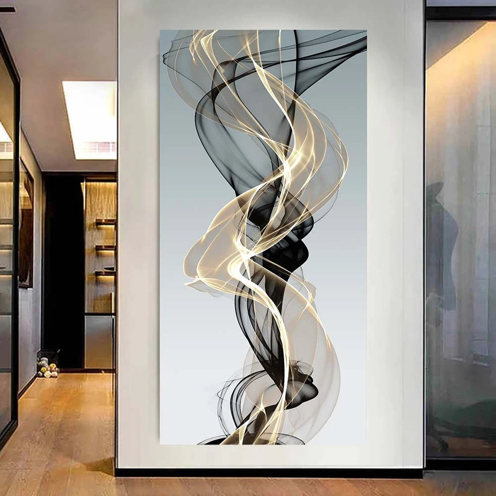 Abstract wall art featuring swirling ribbons of black and gold translucent fabric against a light gray background