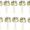 A set of gold geometric flower stands displaying white and cream floral arrangements.