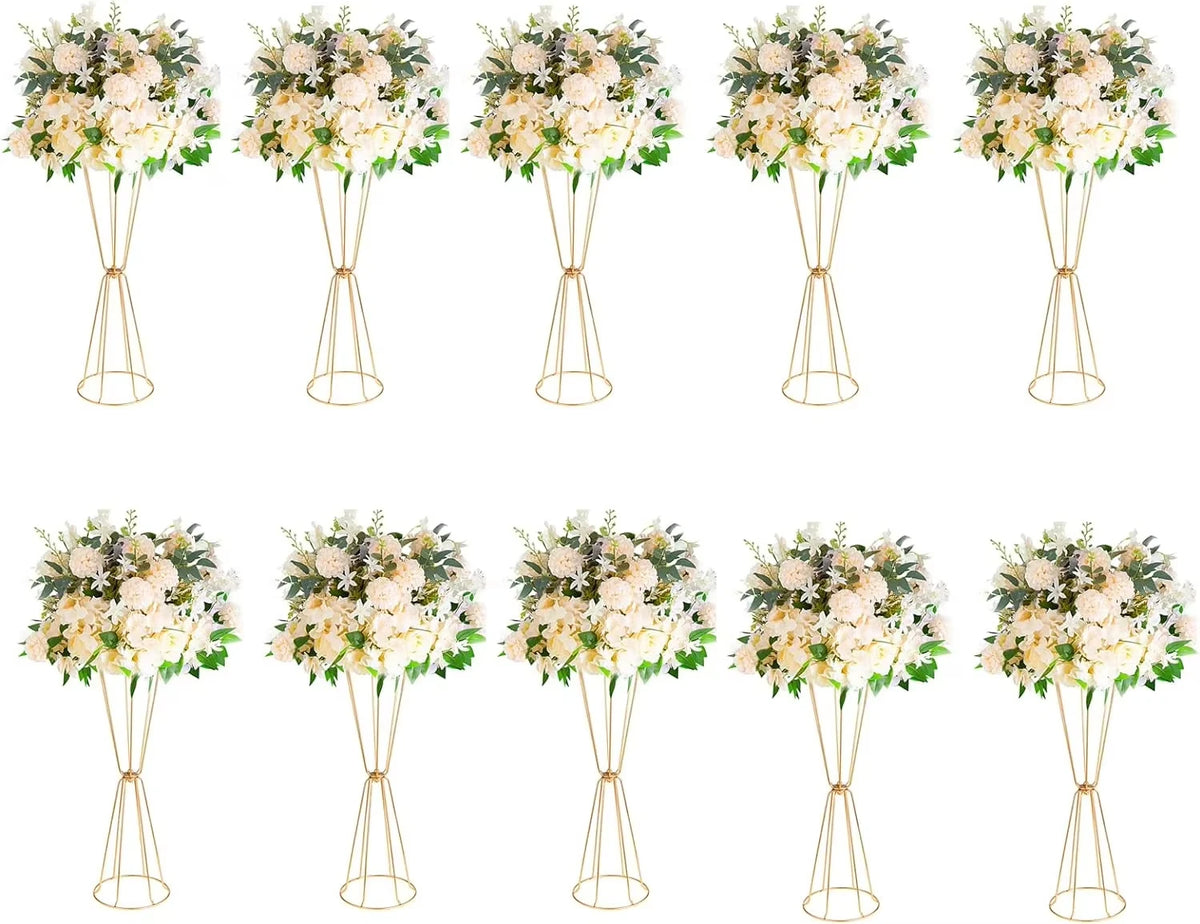 A set of gold geometric flower stands displaying white and cream floral arrangements.