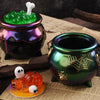 A set of Halloween silicone molds, including a green candle mold and an orange pumpkin mold, displayed on parchment paper.