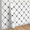 Roll of classic grid peel-and-stick wallpaper featuring a black diamond pattern on a white background.