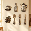 A set of vintage wooden coffee utensils including a decanter, spoon, fork, and knife displayed on a white wall.