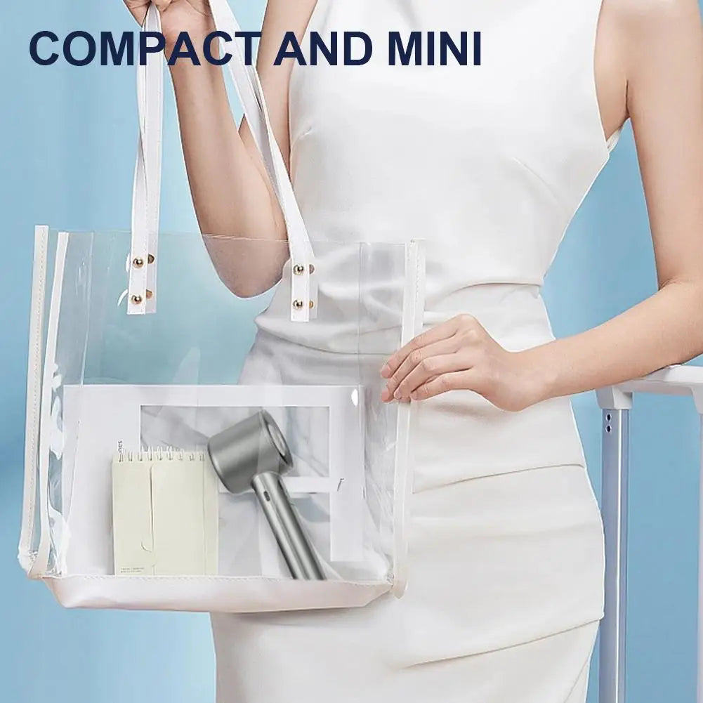 A woman holds a clear plastic bag with a portable rechargeable handheld fan inside, demonstrating its compact size.