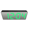 A rectangular digital LED alarm clock displaying the time 12:04 with green digits.
