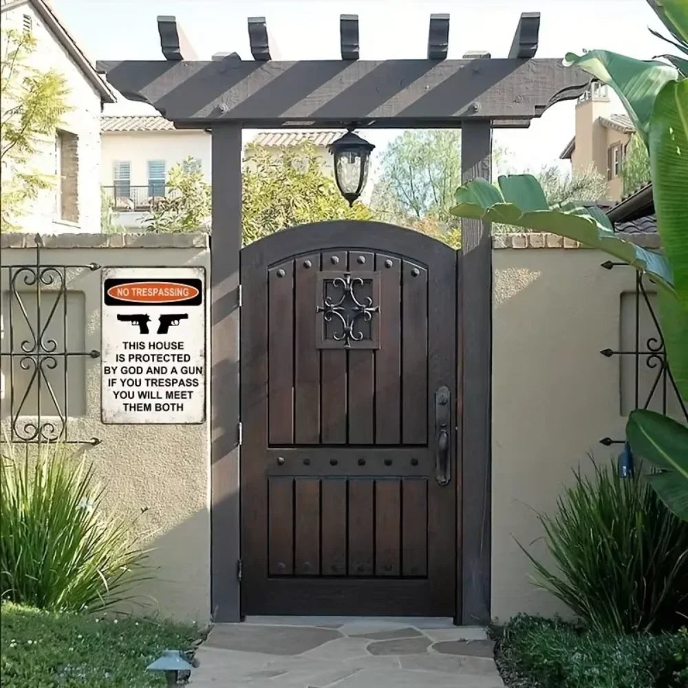 A dark wooden door with a decorative iron sign above it, set within a porch structure.
