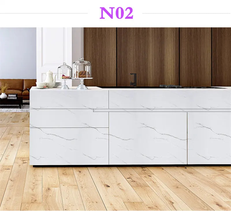 White marble contact paper applied to kitchen cabinetry and countertops in a modern interior setting.