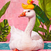 A white duck with a yellow duckling is depicted in a floral portrait style against a pink brick background.