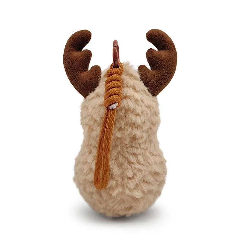 A fluffy tan plush toy resembling a peanut with brown reindeer antlers and an orange scarf.