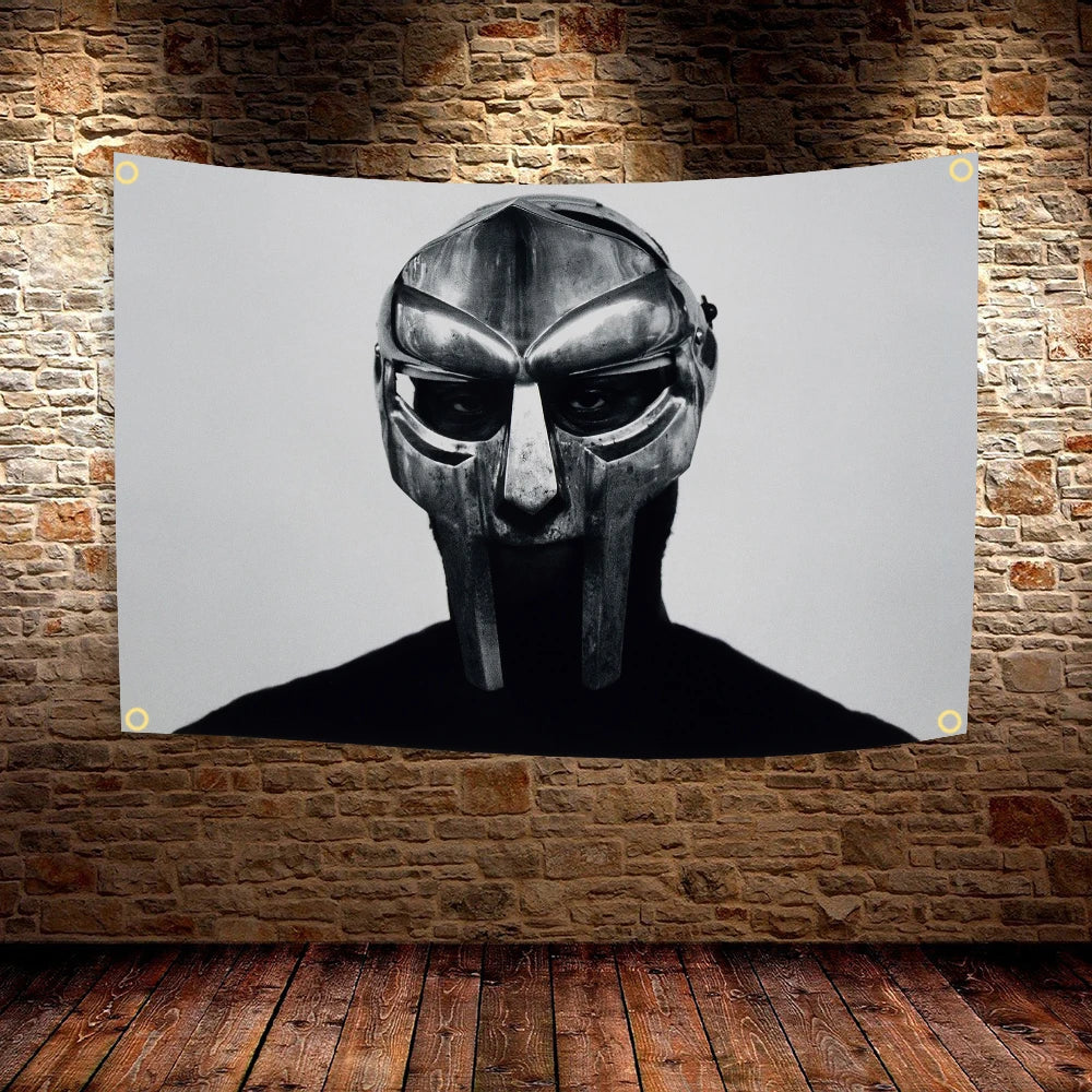 A striking black and white portrait of a stylized, masked face against a light gray background.