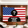 A large American flag tapestry featuring the stars and stripes design displayed on a wooden wall.