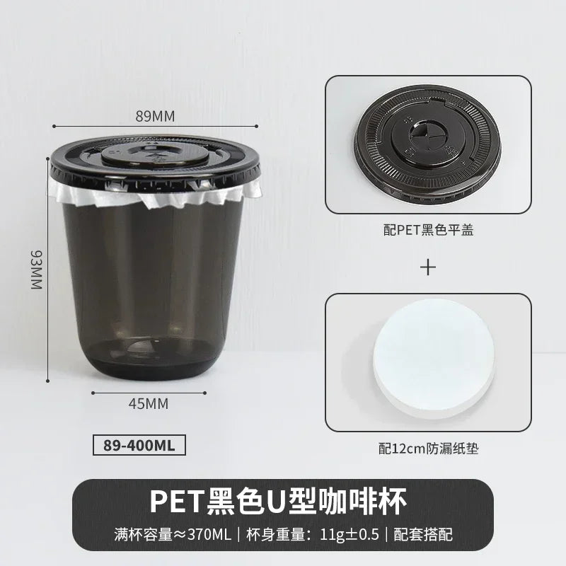 A black disposable U-shaped coffee cup with a lid and a white disc shown next to its dimensions.