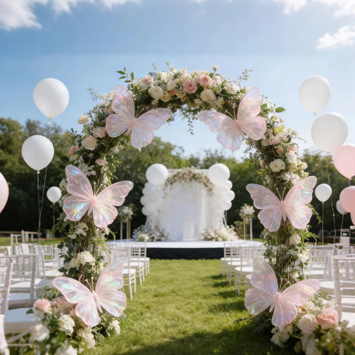 A floral archway decorated with white and pink flowers and butterflies for an outdoor wedding ceremony backdrop.