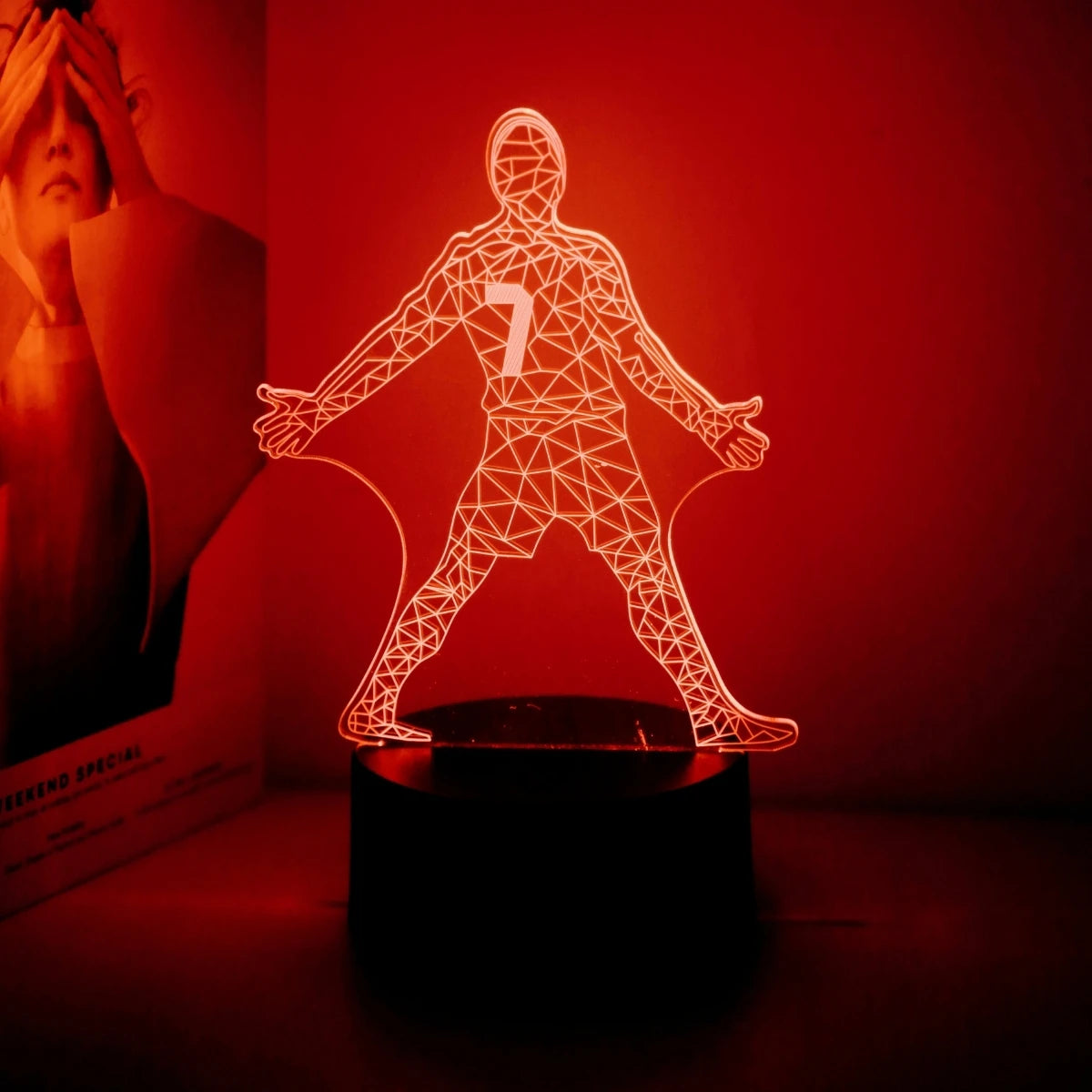 A glowing wireframe figure of a football player with the number 7 stands on a dark base against a red background.
